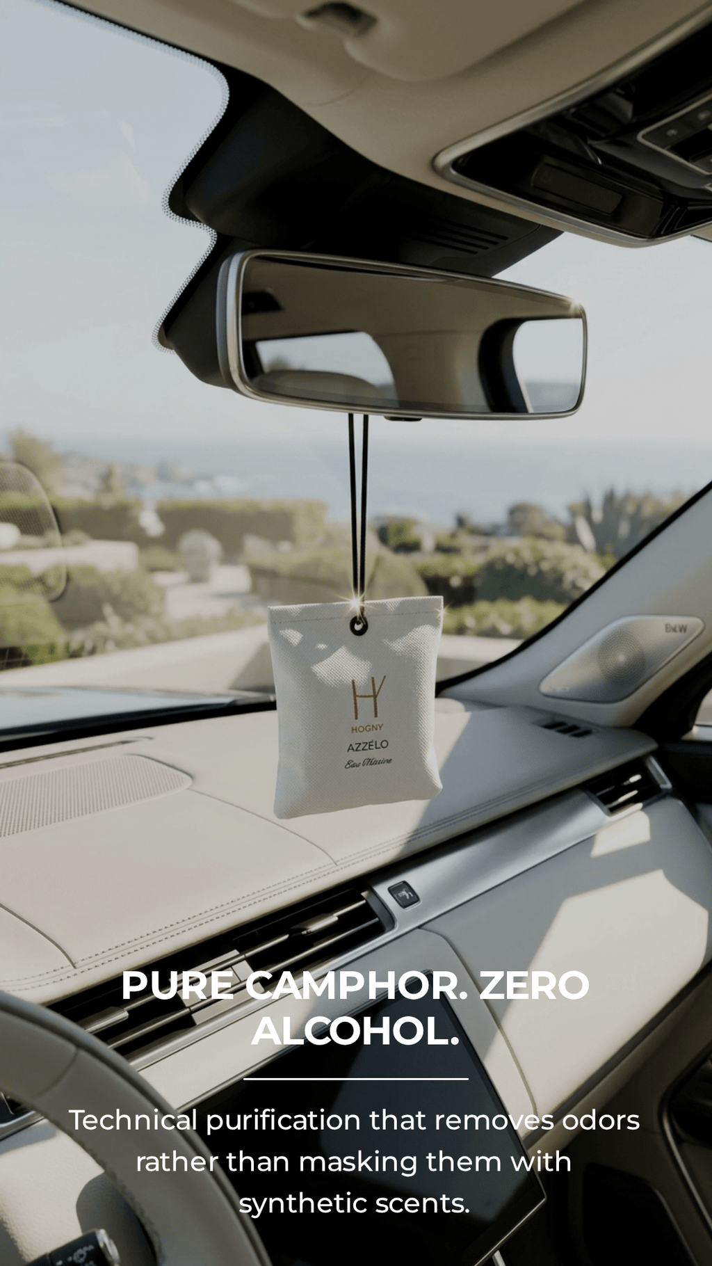 Car air freshener hanging from the rearview mirror with text about pure camphor and zero alcohol.