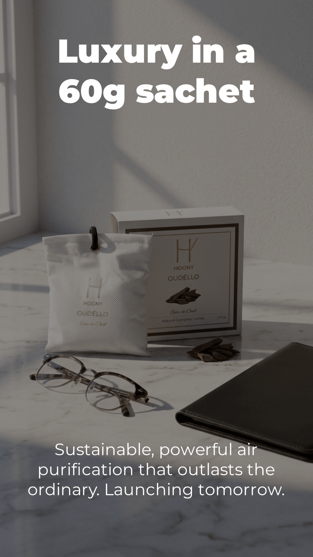 Product packaging with text 'Luxury in a 60g sachet' on a marble surface, depecting the raw natural camphor car perfume power with oud essence.
